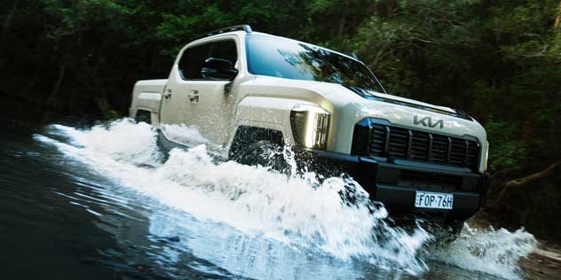 2025 Kia Tasman crossing a ford