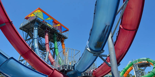 red and blue intertwining slides and slide platform viewed from below